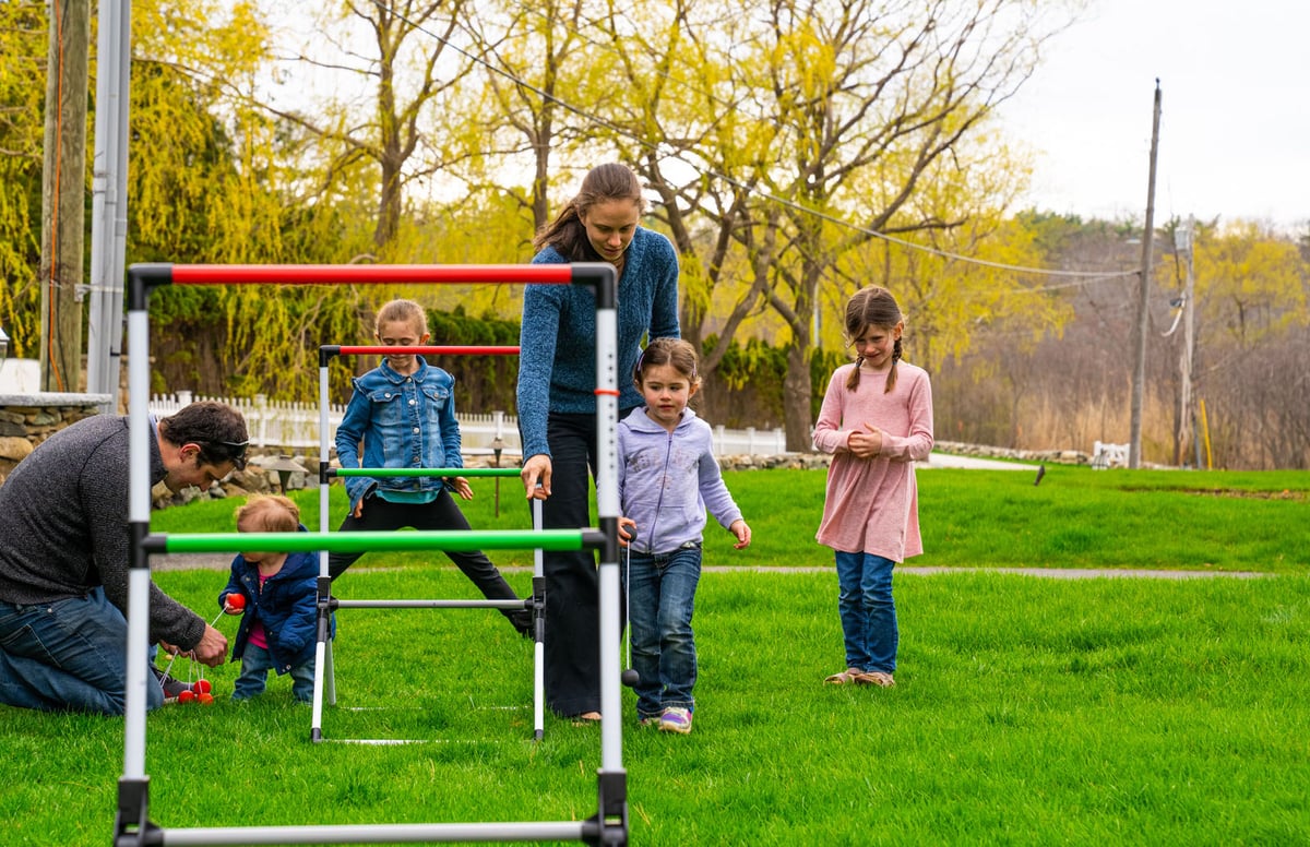 family playing on healthy green grass