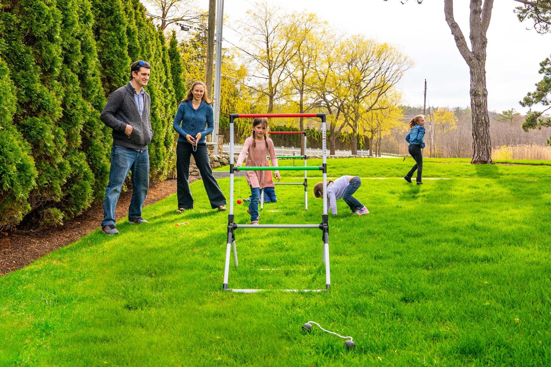 family playing in their lawn without worrying about ticks