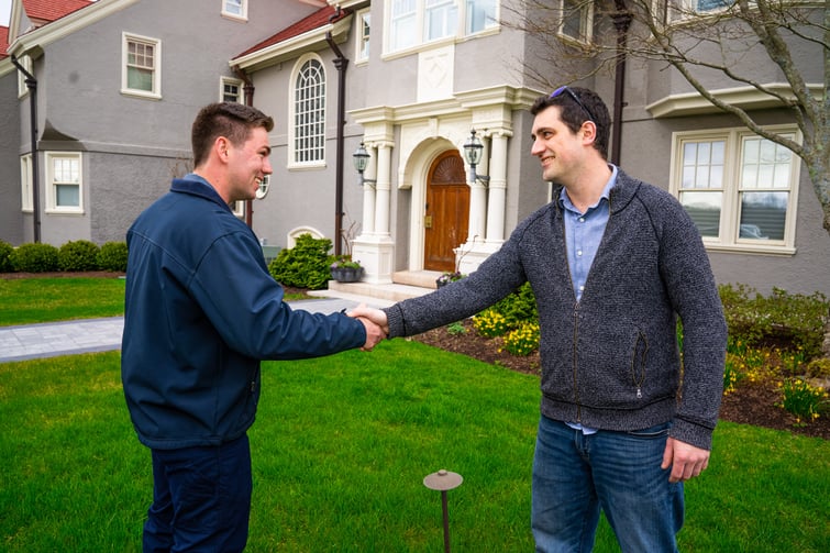 pest control technician greeting a homeowner