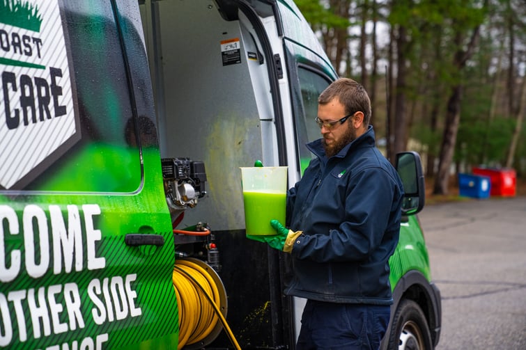 lawn care technician mixing kid safe fertilizer