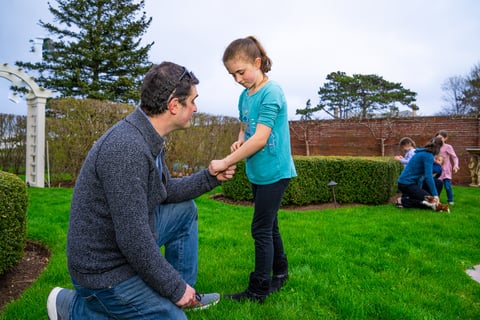 Child with mosquito bite in backyard
