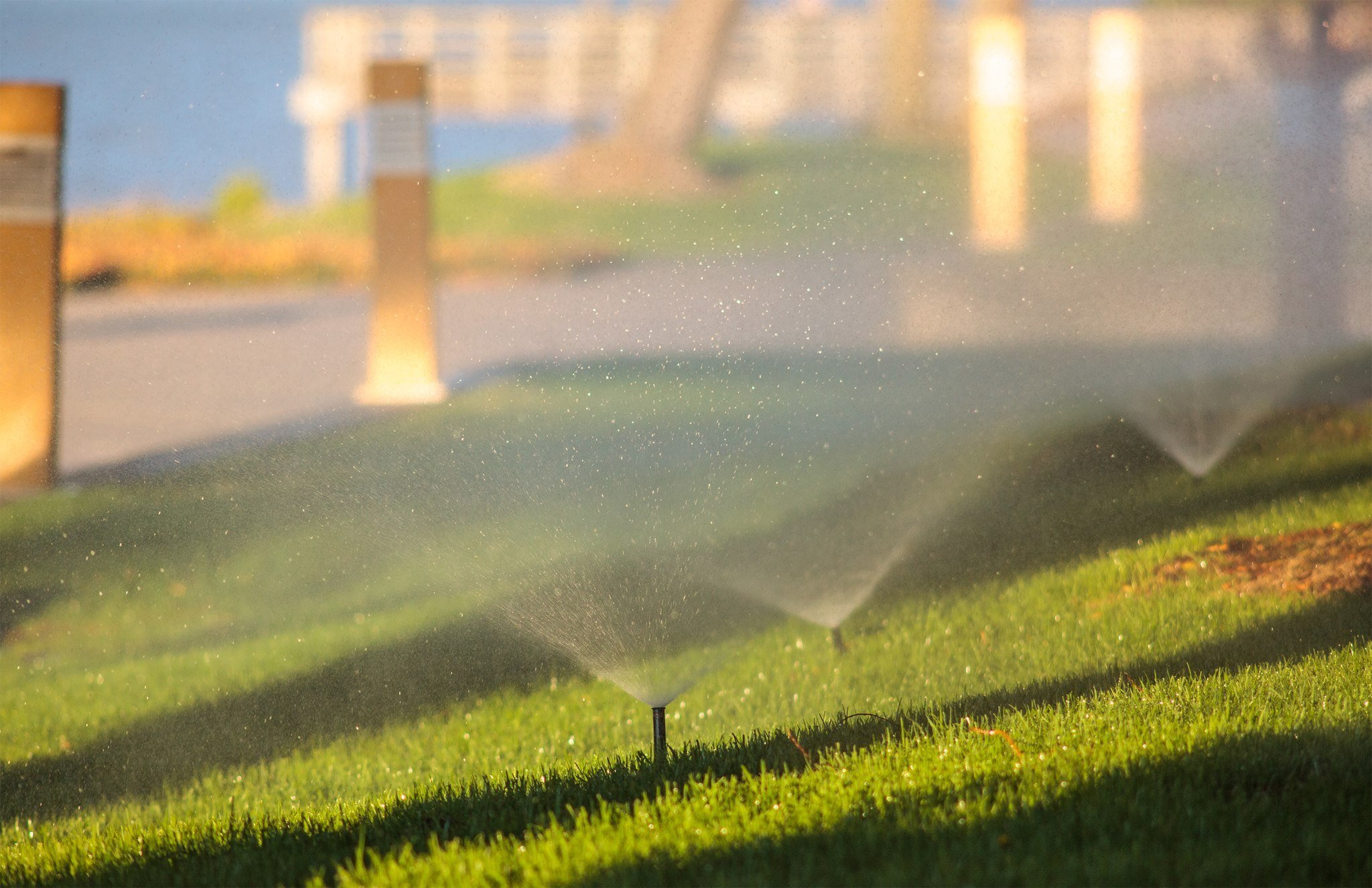 sprinklers watering a new england lawn