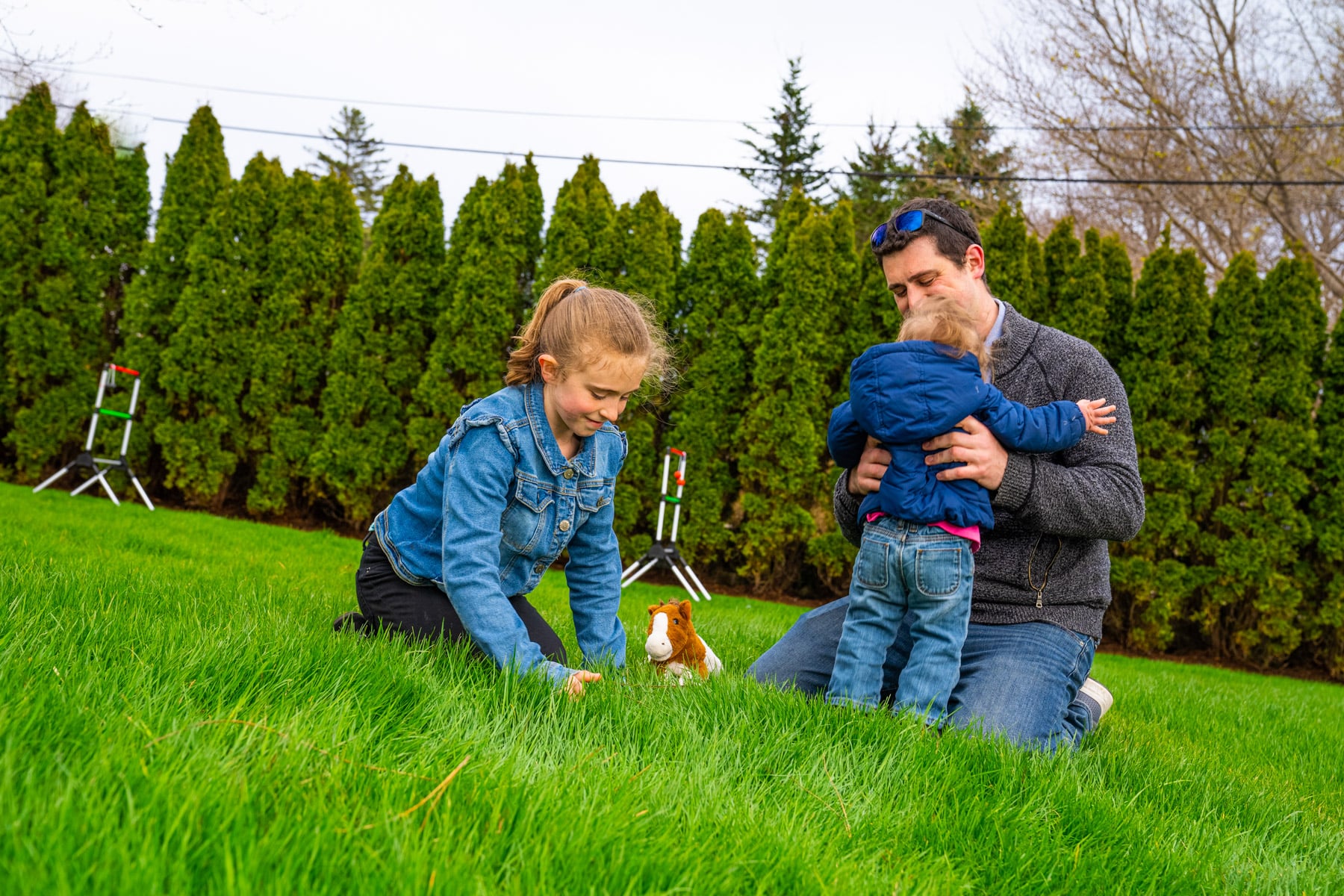 family playing in healthy green grass